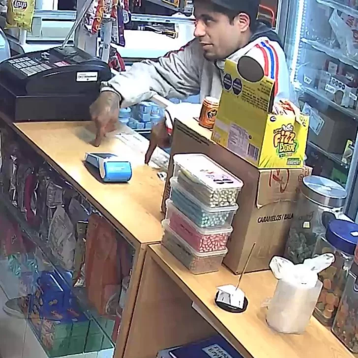El delincuente comprando en un comercio. El delincuente comprando en un comercio.