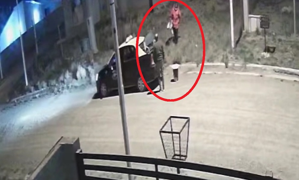  Momento en que el delincuente vuelve del patio con un inodoro, y otros elementos, que el taxista ayuda a guardarlos en el baúl del auto.